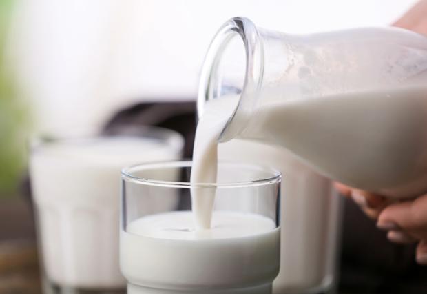 milk pouring into cup