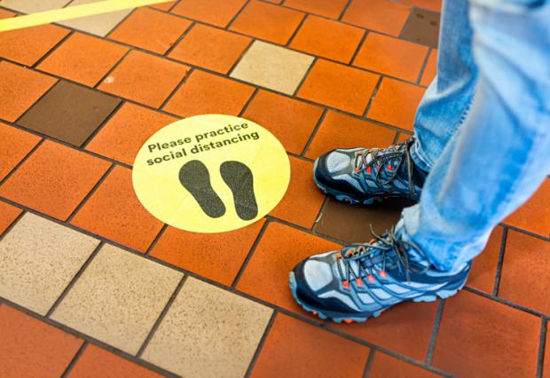 social distancing sign on floor