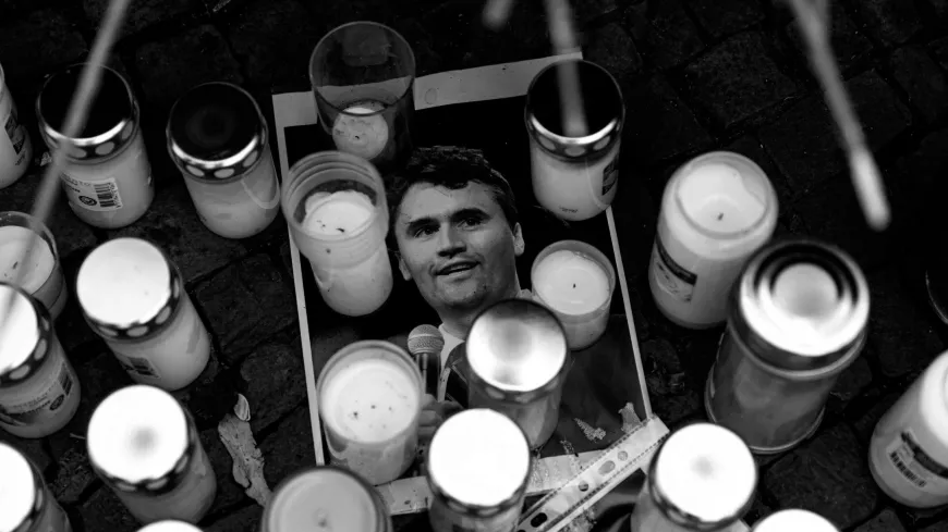 Charlie Kirk's photograph lays under some candles at a vigil held after his assassination
