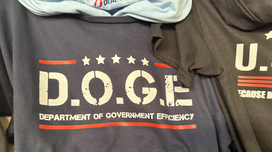 A stack of DOGE t-shirts