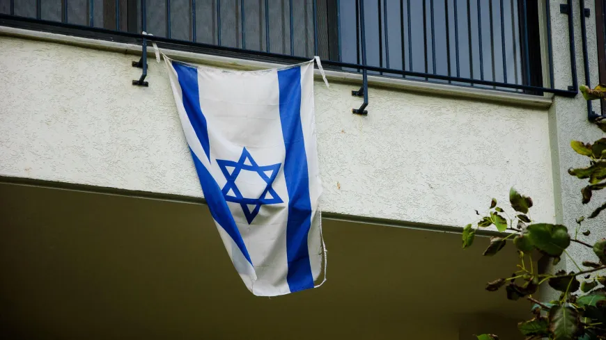 An Israeli flag hangs from a balcony